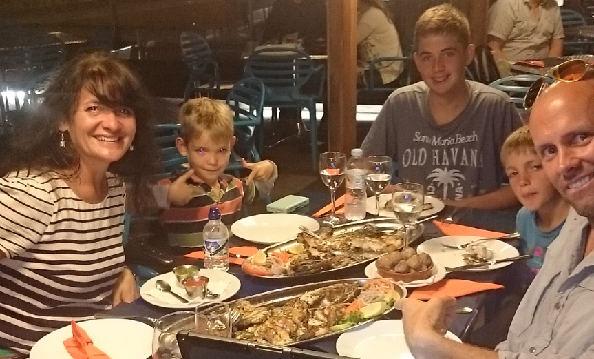 Treating a mother and her sons to a fish dinner (with an entire fish!) in Spain